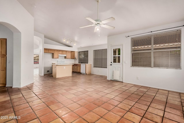 kitchen with a center island, arched walkways, dishwasher, ceiling fan, and vaulted ceiling