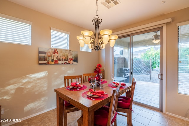 tiled dining space featuring a chandelier