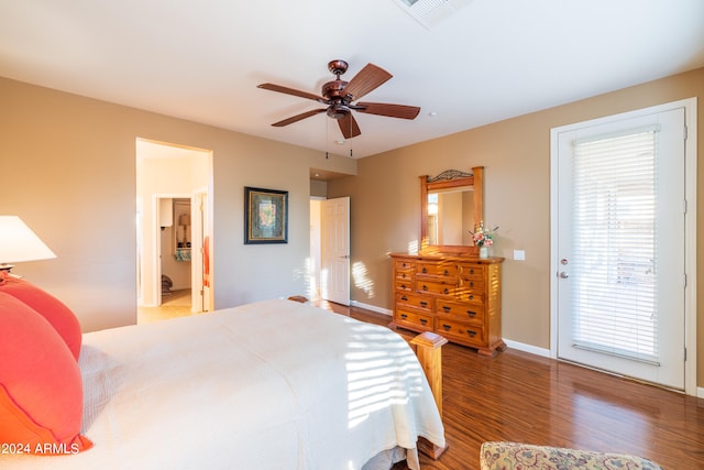 bedroom with access to outside, multiple windows, dark hardwood / wood-style floors, and ceiling fan