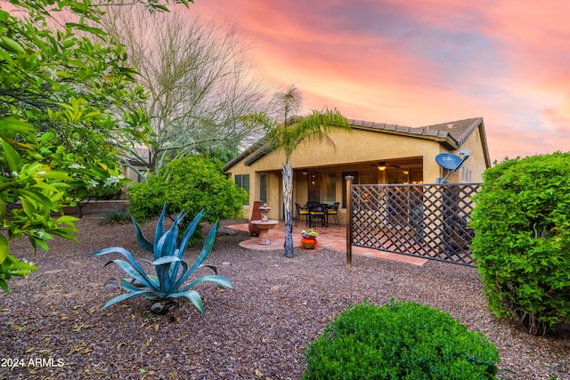 yard at dusk with a patio