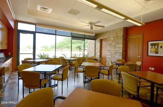 dining room with ceiling fan and tile flooring