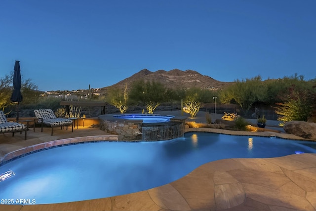 view of pool featuring a mountain view, a patio area, pool water feature, and an in ground hot tub