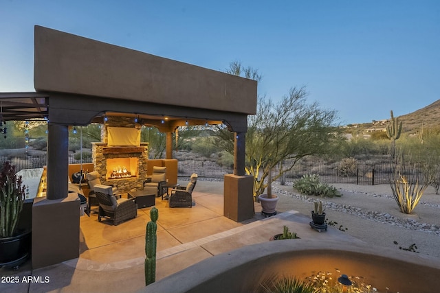 view of patio / terrace with a gazebo and an outdoor living space with a fireplace