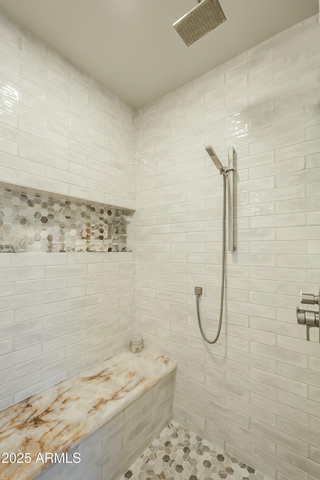 bathroom with a tile shower