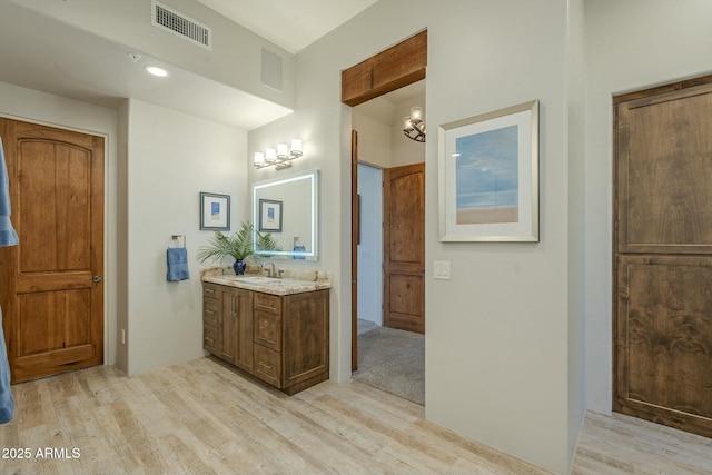 bathroom featuring vanity and hardwood / wood-style floors