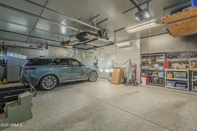 garage with a garage door opener and an AC wall unit