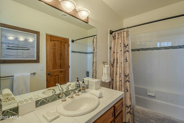 bathroom featuring vanity and shower / bath combo