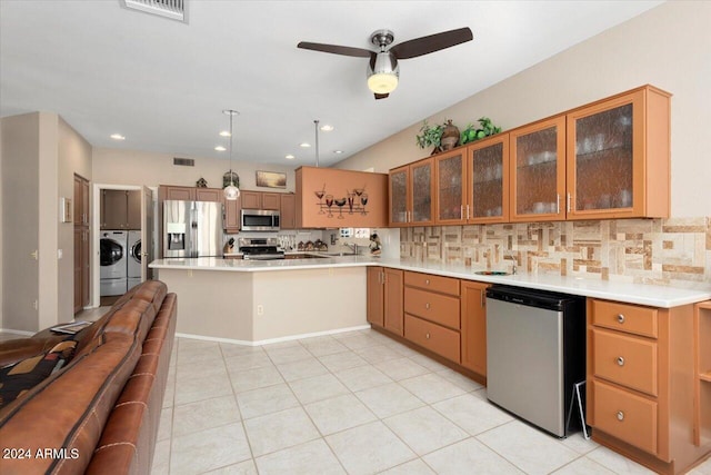 kitchen featuring decorative backsplash, stainless steel appliances, light tile patterned flooring, washing machine and dryer, and ceiling fan