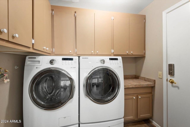 laundry area featuring cabinets and washer and clothes dryer