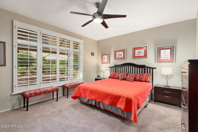 bedroom with ceiling fan and light carpet