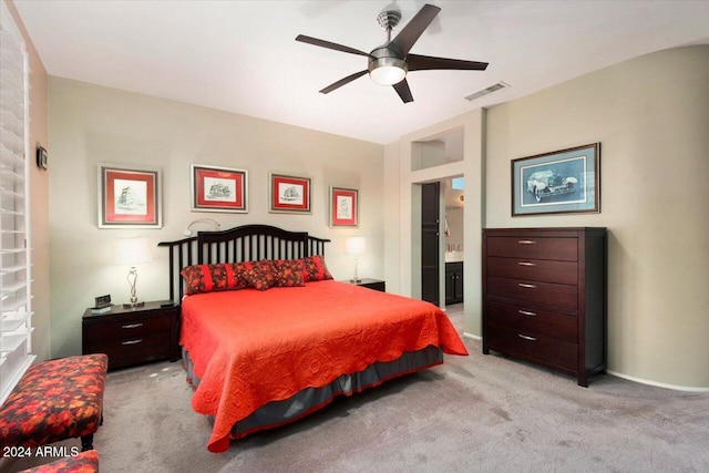 carpeted bedroom featuring connected bathroom and ceiling fan