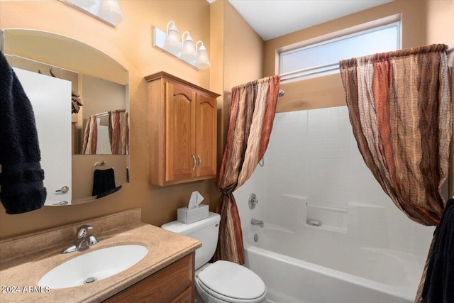 full bathroom featuring vanity, shower / bath combo with shower curtain, and toilet