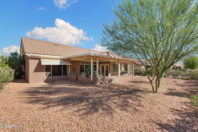 rear view of house with a patio and a sunroom