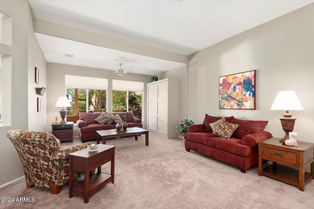 living room with light colored carpet and ceiling fan