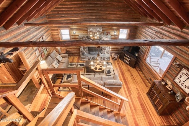 669 W Monarch Cir, Lakeside, AZ 85929 - living room with high vaulted ceiling, beamed ceiling, hardwood / wood-style floors, and an inviting chandelier