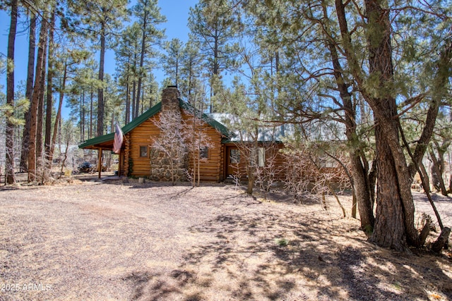 669 W Monarch Cir, Lakeside, AZ 85929 - view of home's exterior with log siding and a chimney