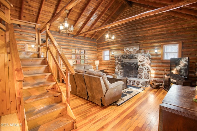 669 W Monarch Cir, Lakeside, AZ 85929 - living room featuring hardwood / wood-style floors, high vaulted ceiling, a stone fireplace, and stairs