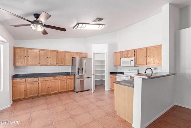 kitchen with a ceiling fan, white appliances, dark countertops, and visible vents