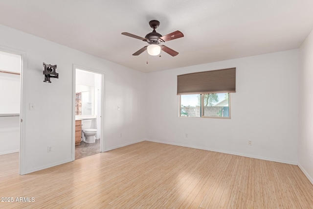 unfurnished room with a ceiling fan, light wood-type flooring, and baseboards