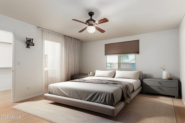 bedroom with light wood-style flooring, baseboards, and ceiling fan