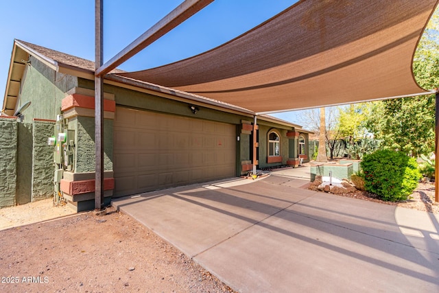 view of front of home featuring an attached garage and concrete driveway