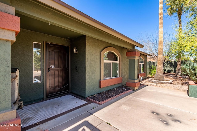 doorway to property with stucco siding