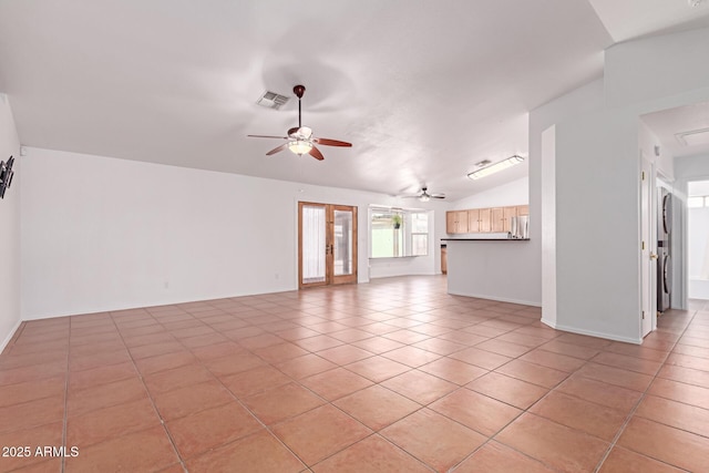 unfurnished living room with visible vents, baseboards, light tile patterned flooring, lofted ceiling, and ceiling fan