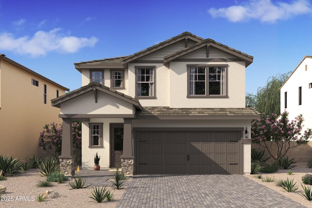 view of front of property with a garage, a tile roof, decorative driveway, and stucco siding