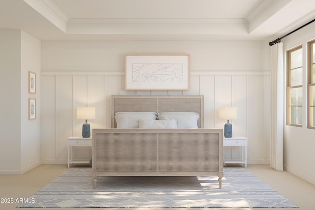 carpeted bedroom with ornamental molding, a raised ceiling, and a decorative wall