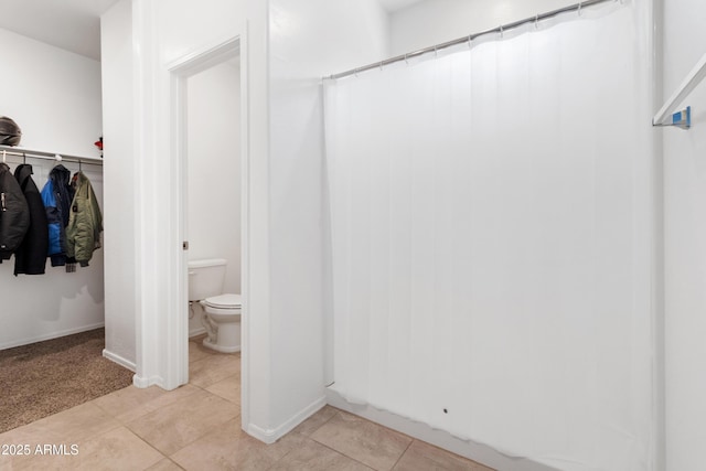 bathroom with tile patterned floors and toilet