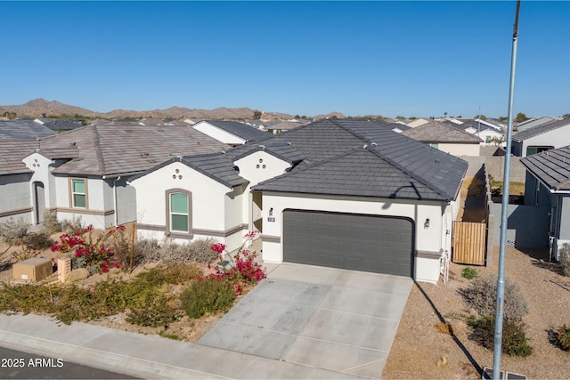 view of front facade with a mountain view and a garage