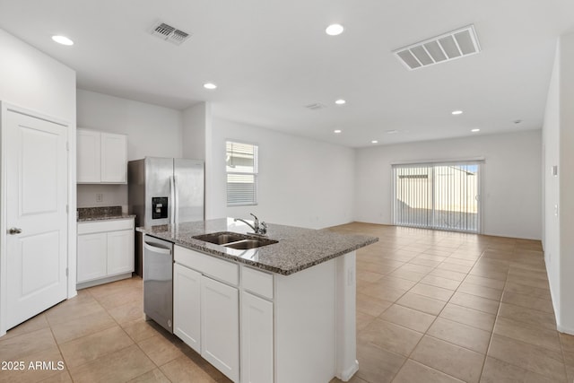 kitchen featuring white cabinetry, a kitchen island with sink, sink, and stainless steel appliances