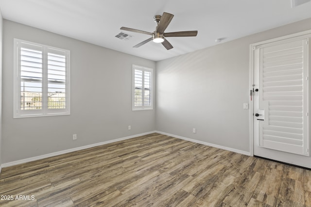 unfurnished room featuring hardwood / wood-style flooring and ceiling fan