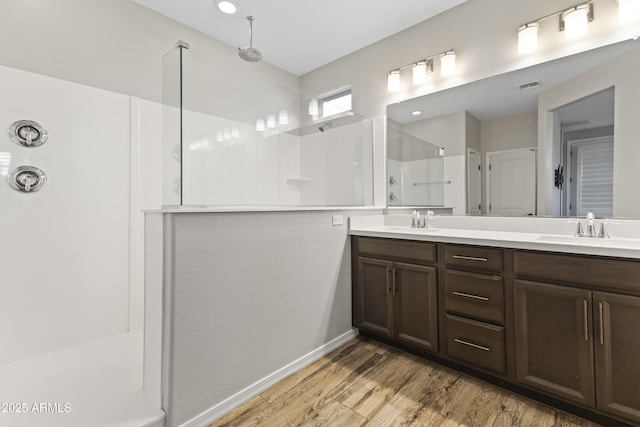 bathroom with vanity, hardwood / wood-style floors, and a shower