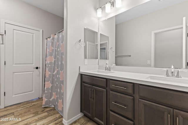 bathroom featuring wood-type flooring, vanity, and walk in shower