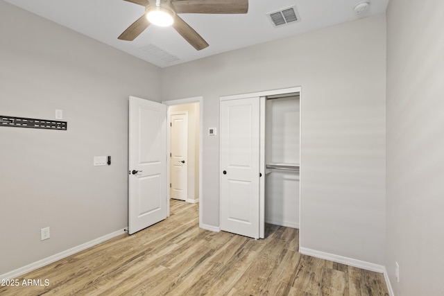 unfurnished bedroom featuring light hardwood / wood-style floors, a closet, and ceiling fan