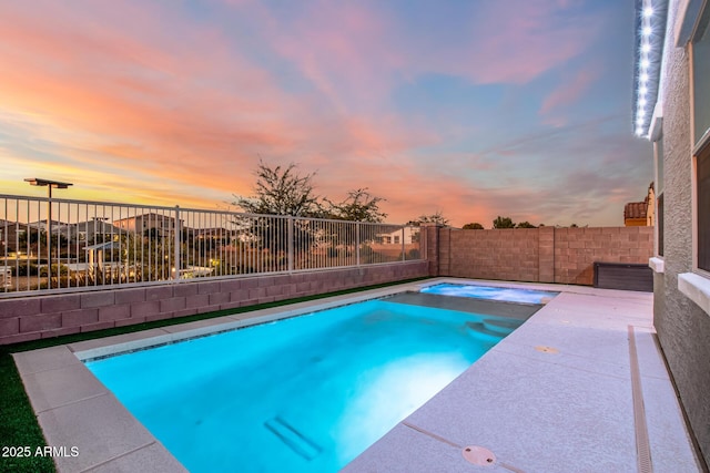 pool at dusk featuring a patio