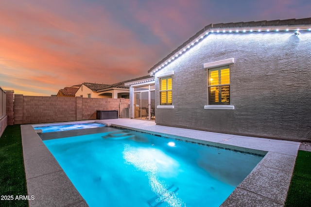 pool at dusk with a patio