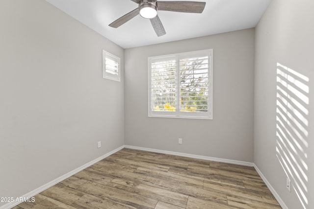 empty room with ceiling fan and light hardwood / wood-style floors