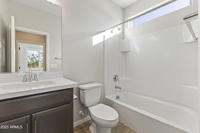 full bathroom featuring vanity, wood-type flooring, washtub / shower combination, and toilet