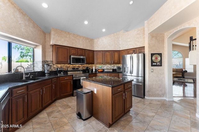 29806 N 43rd Pl, Cave Creek, AZ 85331 - kitchen with tasteful backsplash, arched walkways, a sink, appliances with stainless steel finishes, and a kitchen island