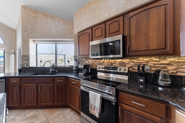 29806 N 43rd Pl, Cave Creek, AZ 85331 - kitchen with appliances with stainless steel finishes, dark stone countertops, light tile patterned flooring, decorative backsplash, and a sink