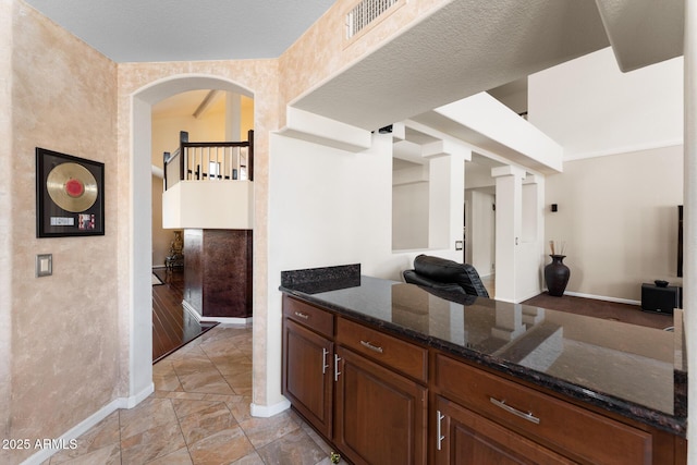 29806 N 43rd Pl, Cave Creek, AZ 85331 - kitchen with visible vents, baseboards, and dark stone counters