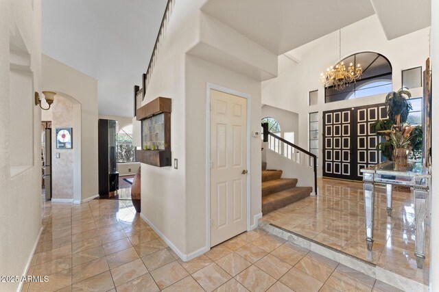 29806 N 43rd Pl, Cave Creek, AZ 85331 - foyer entrance featuring baseboards, an inviting chandelier, a towering ceiling, and stairs
