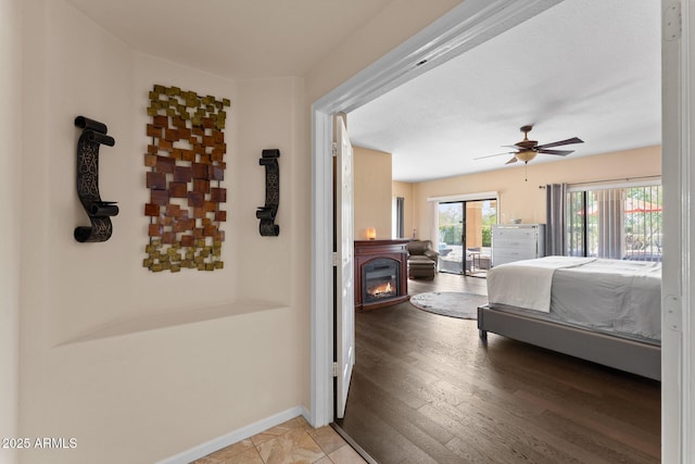 29806 N 43rd Pl, Cave Creek, AZ 85331 - bedroom featuring a glass covered fireplace, access to outside, baseboards, and a ceiling fan