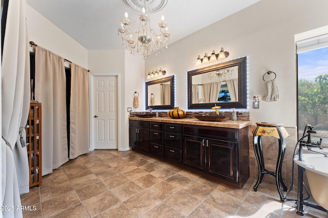 29806 N 43rd Pl, Cave Creek, AZ 85331 - bathroom featuring a soaking tub, stone finish floor, a chandelier, a sink, and double vanity