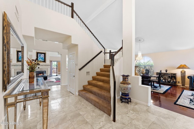 29806 N 43rd Pl, Cave Creek, AZ 85331 - staircase featuring a lit fireplace, a high ceiling, and baseboards