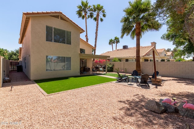 3222 E Cortez St, Phoenix, AZ 85028 - rear view of house featuring stucco siding, a patio area, and an outdoor fire pit