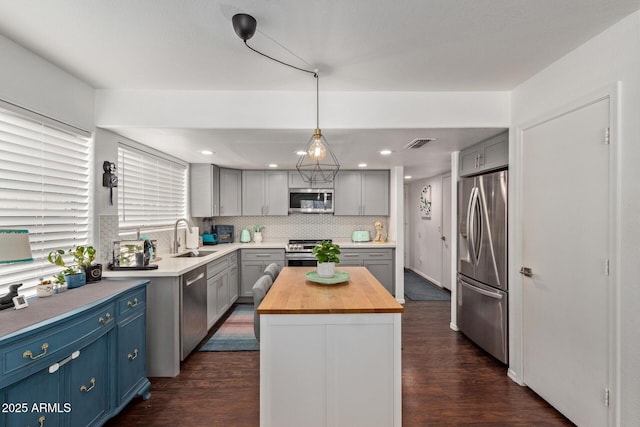 3222 E Cortez St, Phoenix, AZ 85028 - kitchen with stainless steel appliances, butcher block countertops, a sink, dark wood-style floors, and recessed lighting