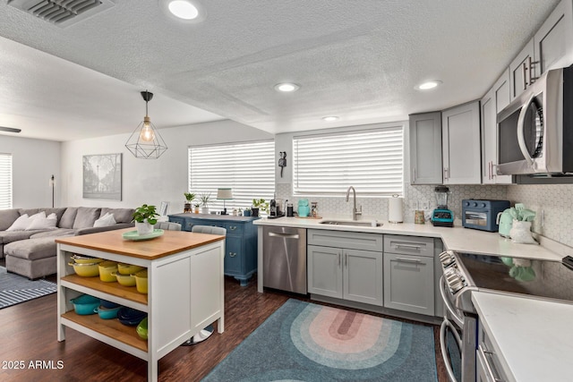 3222 E Cortez St, Phoenix, AZ 85028 - kitchen featuring a sink, appliances with stainless steel finishes, healthy amount of natural light, open floor plan, and a textured ceiling